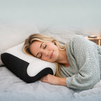 Woman resting comfortably on the OrthoCloud contour pillow designed for ergonomic neck and shoulder support.